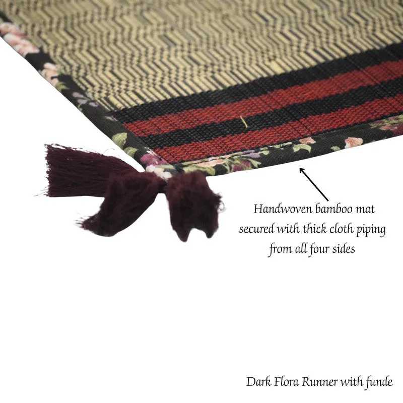 Close view of textured runner with floral edging and dark tassel detail