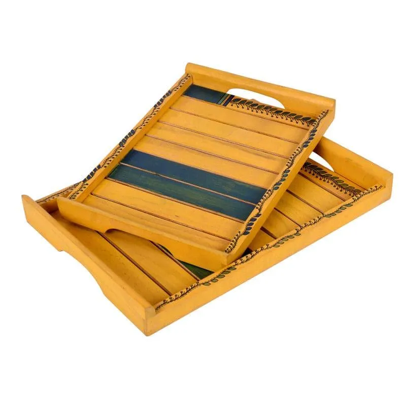 Two yellow wooden serving trays with leafy borders and green striped detailing, stacked together