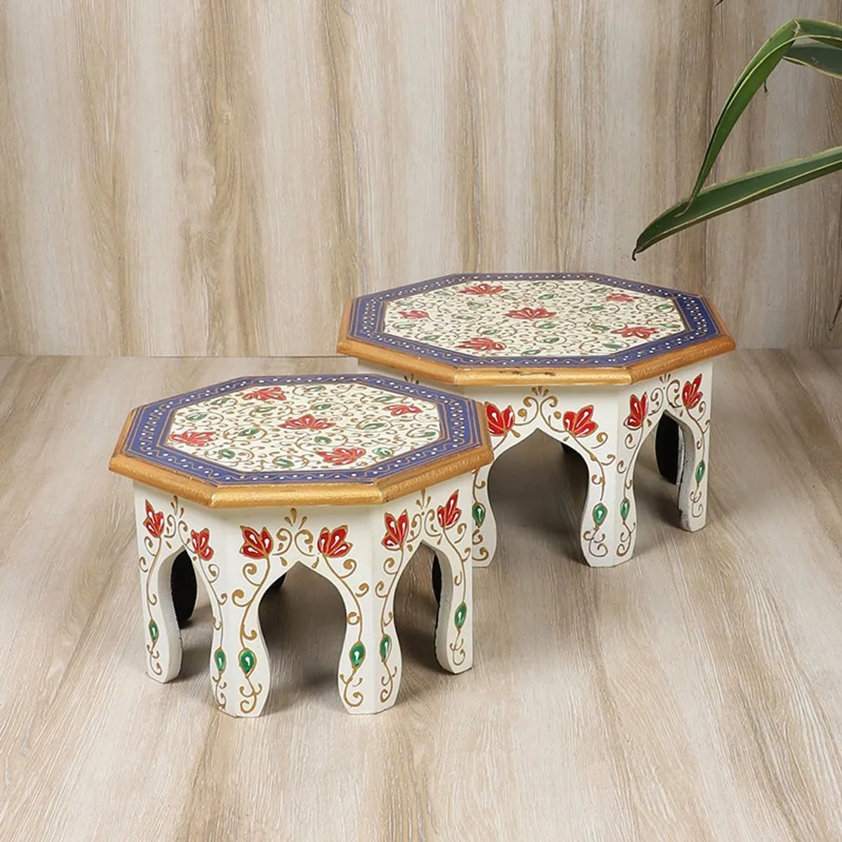 Pair of decorated octagonal stools shown from the front with floral motifs