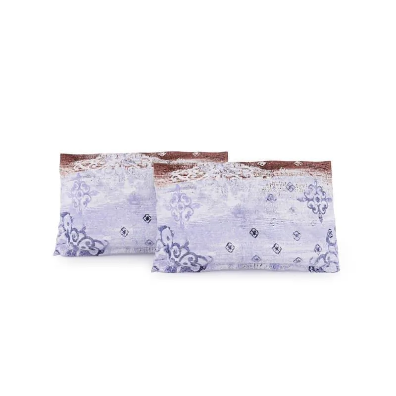 Two matching pillow covers in a blue and brown ethnic print