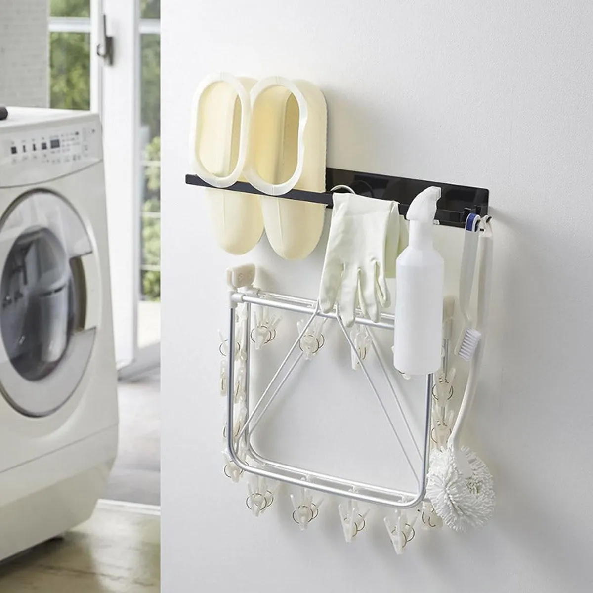 Black magnetic wall organiser holding slippers, gloves, spray bottle and clips
