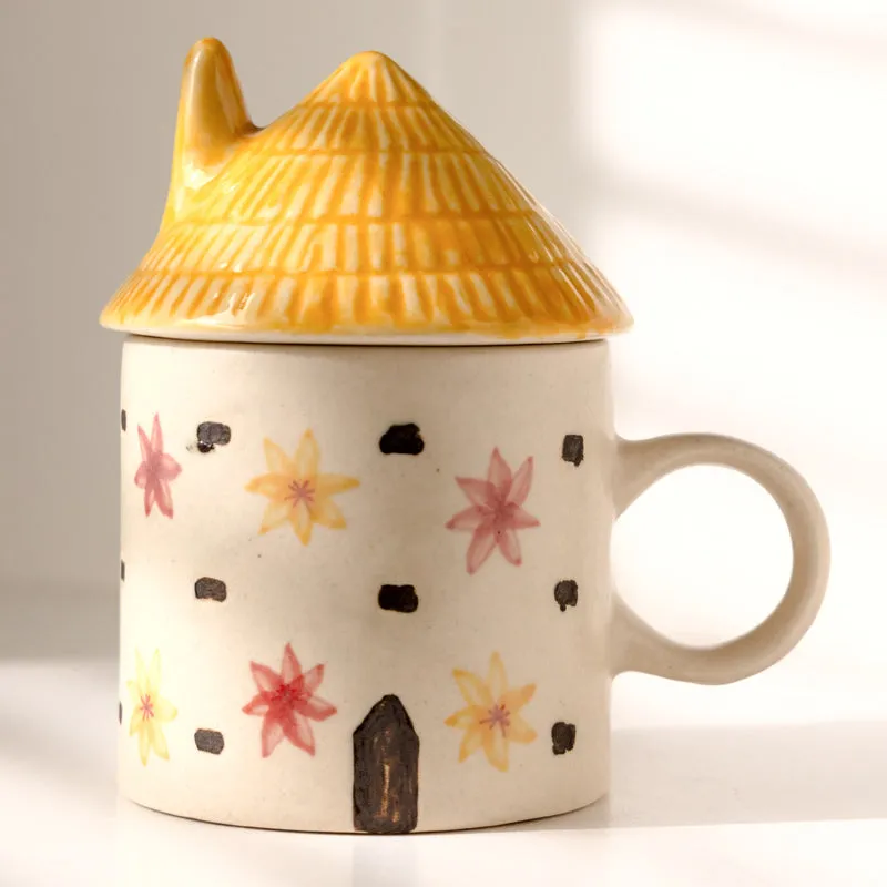 Close view of glossy yellow lid and floral ceramic mug design