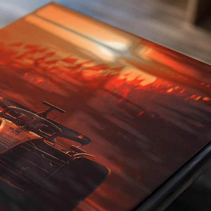 Close-up of race car poster with glossy surface and orange-red tones