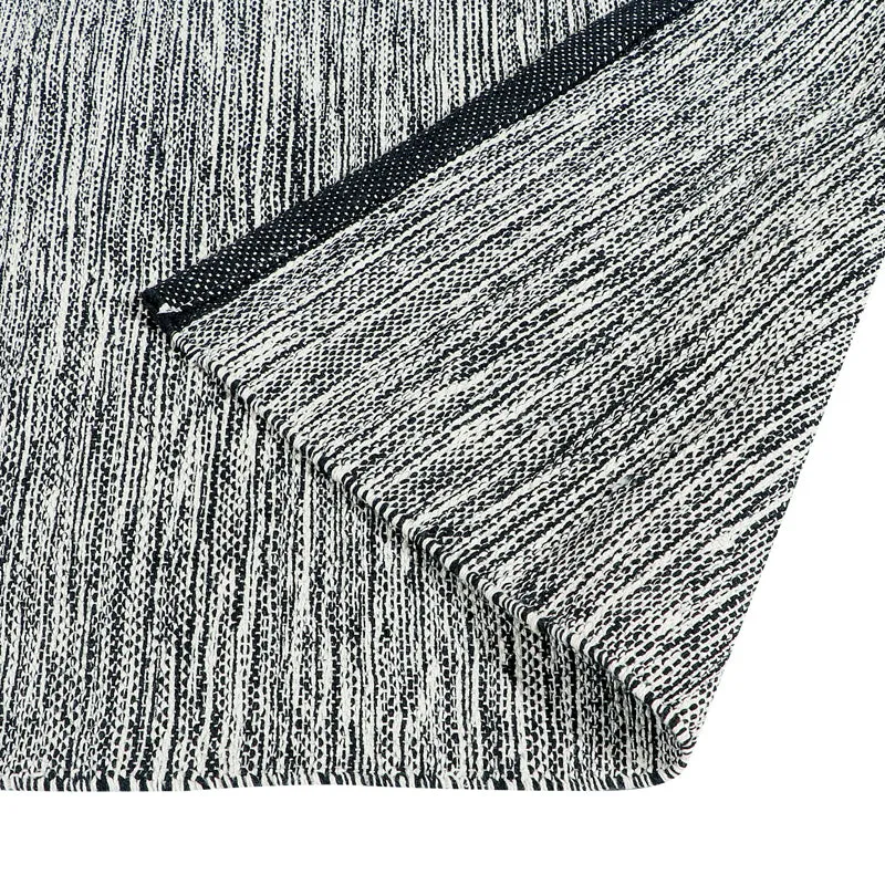 Close-up of the runner rug corner showing the abstract linear pattern and dark border.