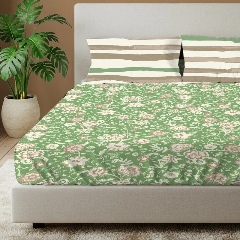 Close view of green floral bedsheet with two striped pillow covers