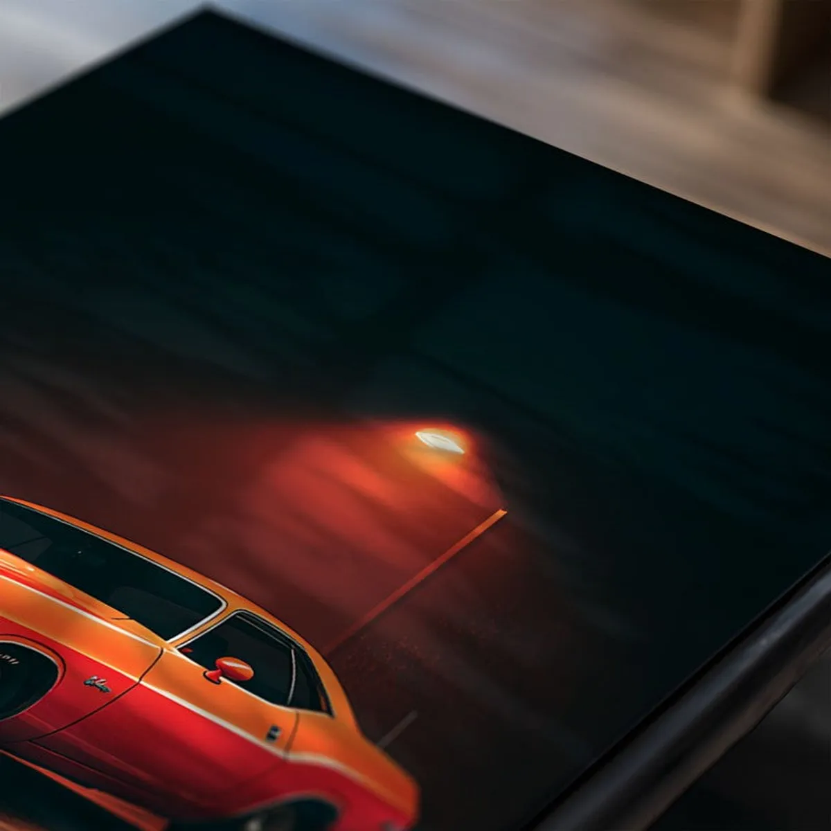 Close-up of a car poster showing a vintage orange car at night