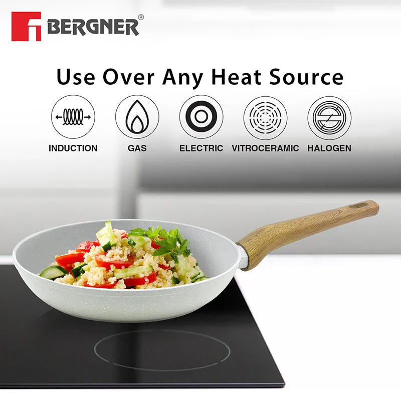 White frying pan shown on a black induction cooktop