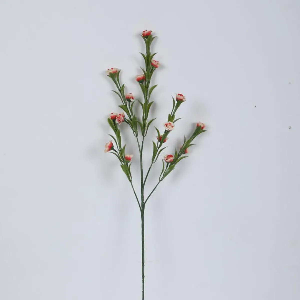 Single pink faux mini rose bloom stem on a plain background