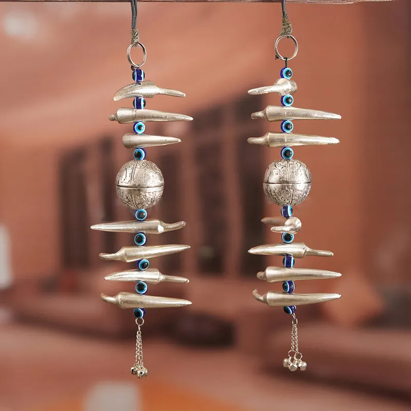 Two silver hanging latkans with engraved round centre pieces and blue accents