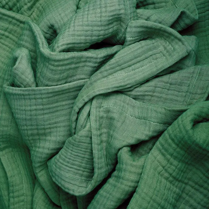 Close-up view of the green crinkled self-design cotton fabric