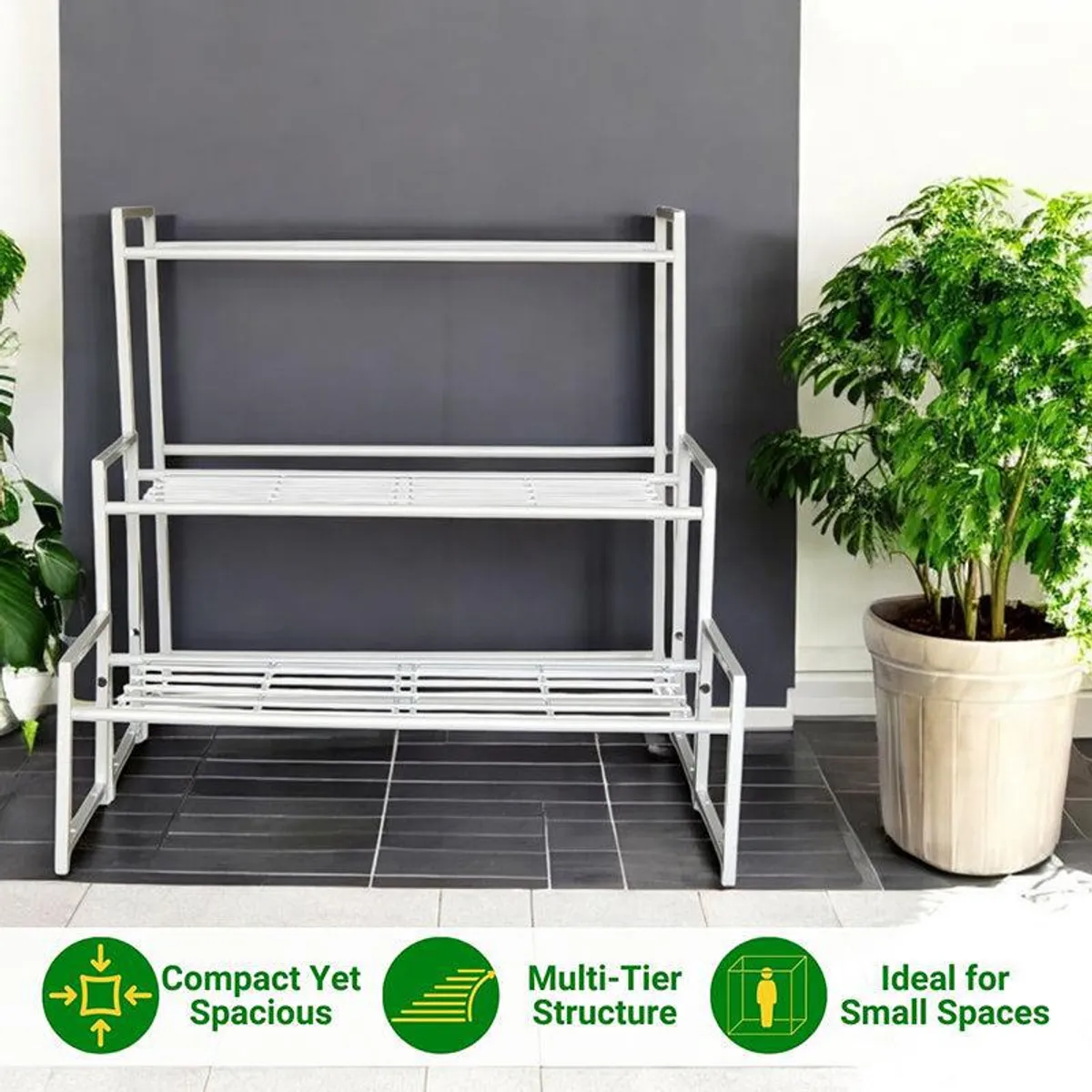 Front view of a white three-tier metal planter stand beside potted plants