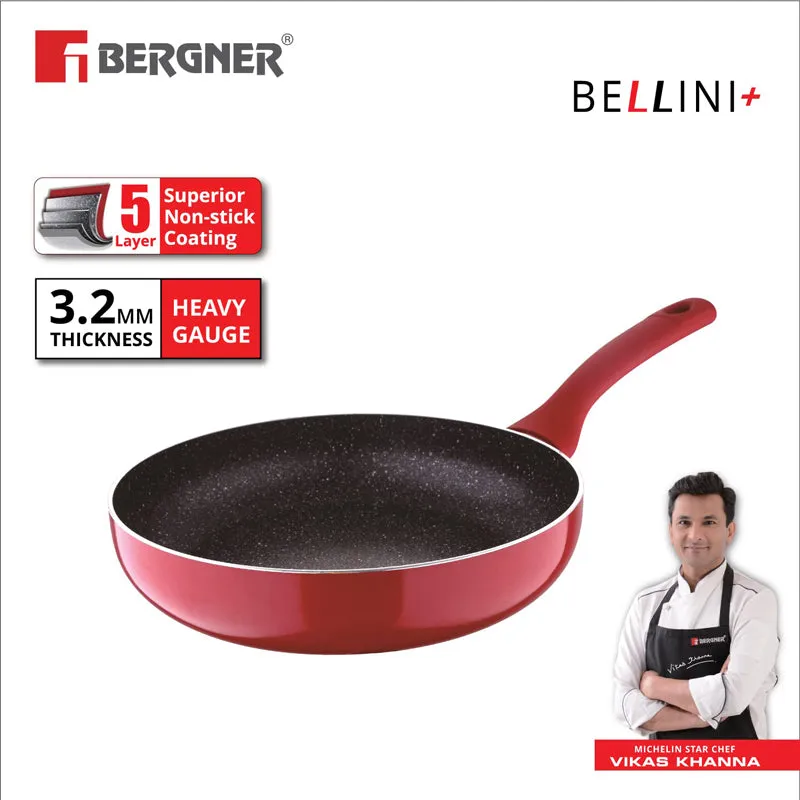 Red Bergner Bellini Plus frypan shown at an angle with a black speckled interior