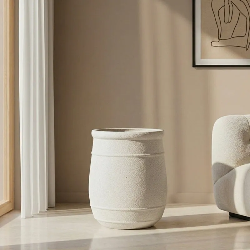 Off-white empty cylindrical planter showing its open top and matte textured finish