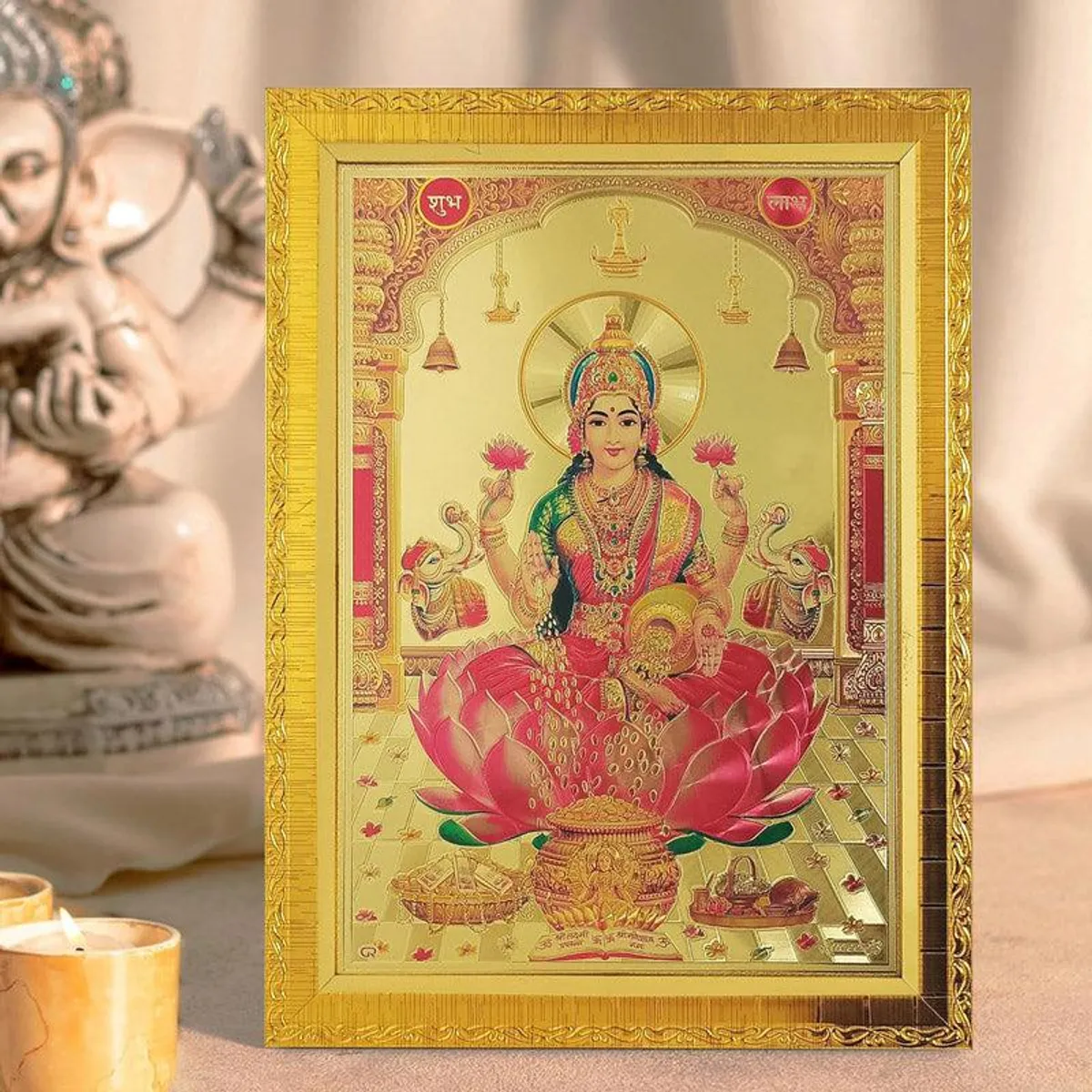 Close view of Lakshmi devotional image in an ornate gold rectangular frame