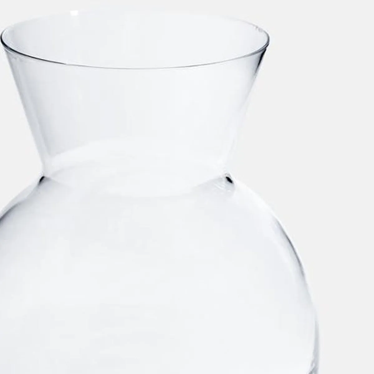 Close-up of the flared neck of a clear glass vase
