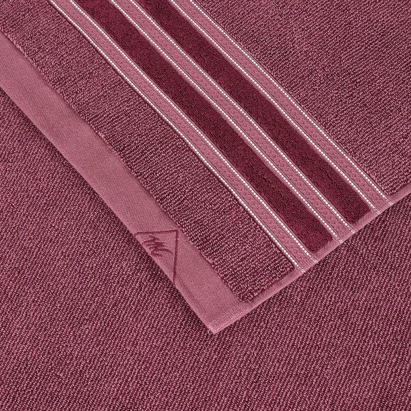 Close-up of the towel's maroon striped border and soft textured fabric