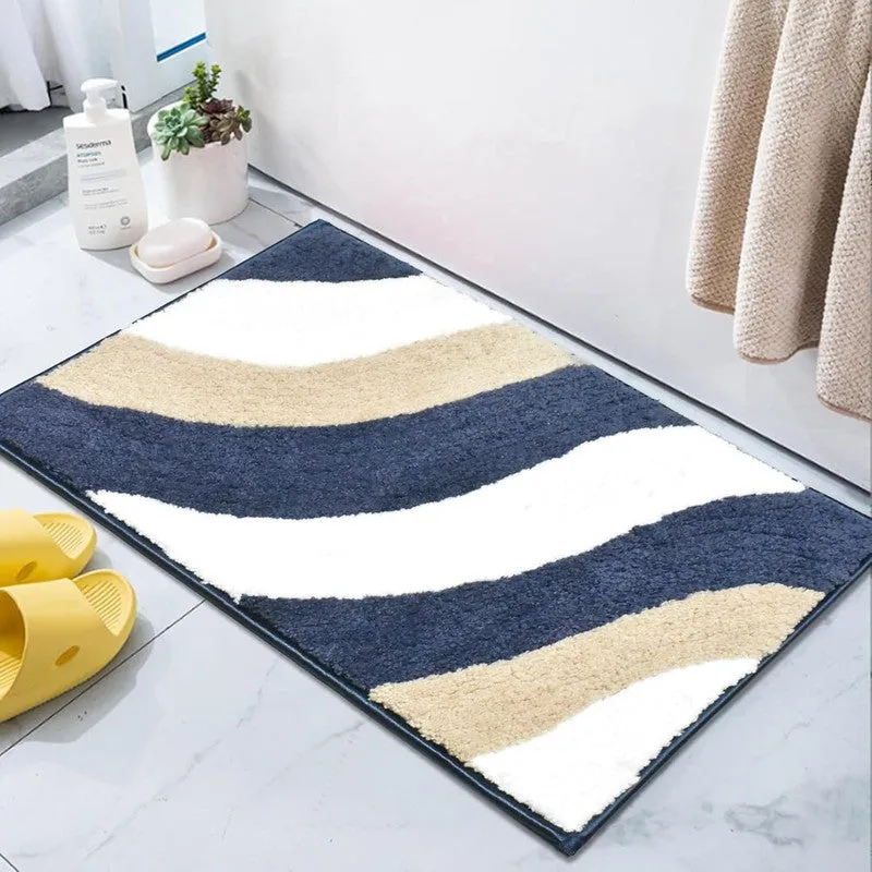 Rectangular microfibre bath mat in blue, white and beige placed beside a bathroom counter