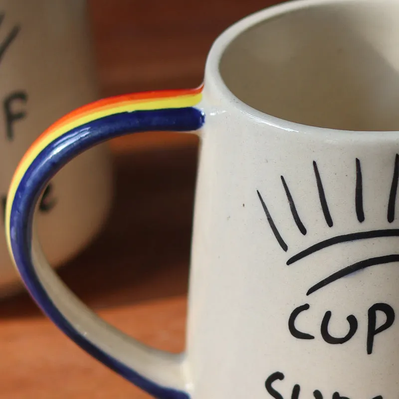 Close-up of the mug's colourful handle and sunshine lettering