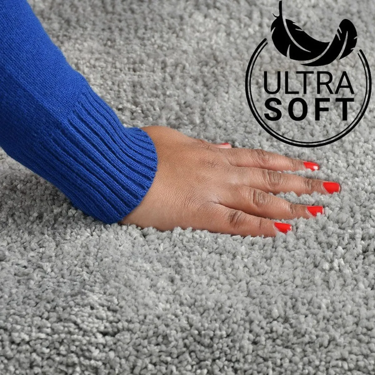 Hand pressing into the soft grey micro fiber bath mat