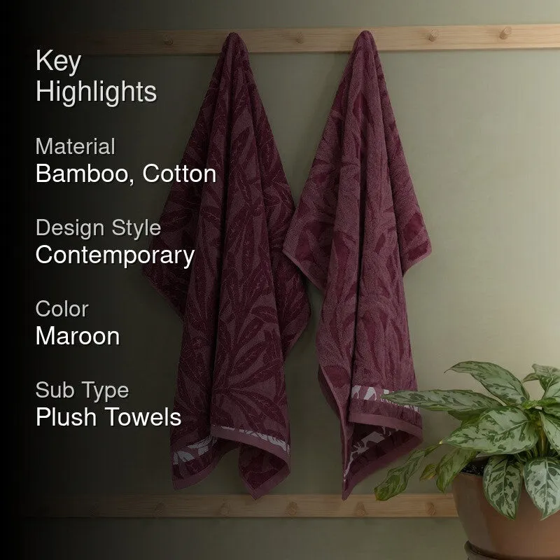 Maroon floral bath towels displayed in a bathroom setting.