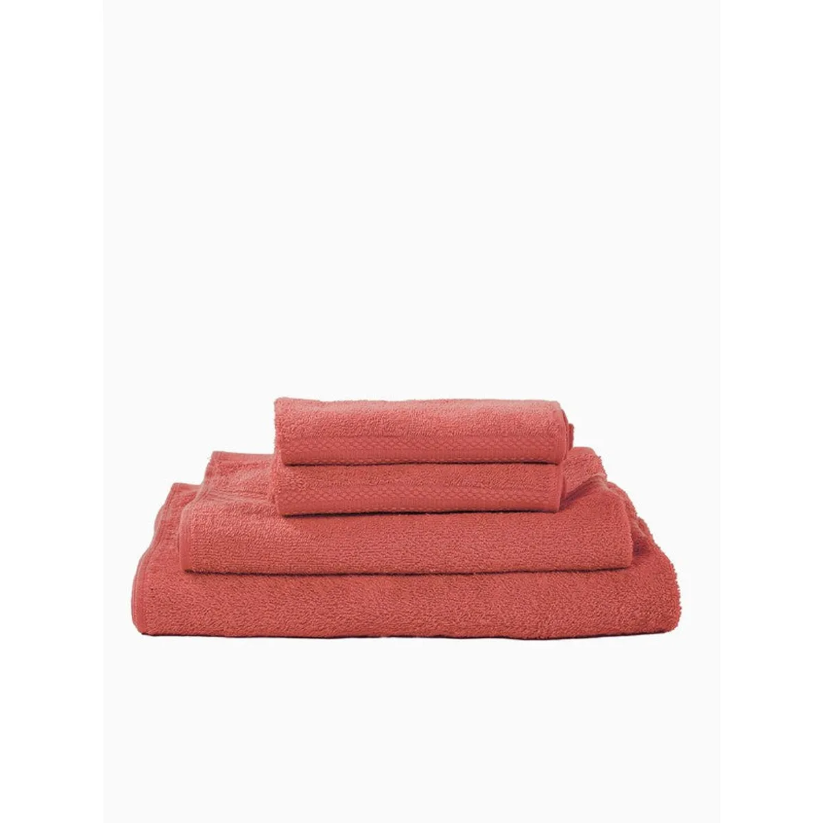 Peach towels folded in a neat stacked arrangement
