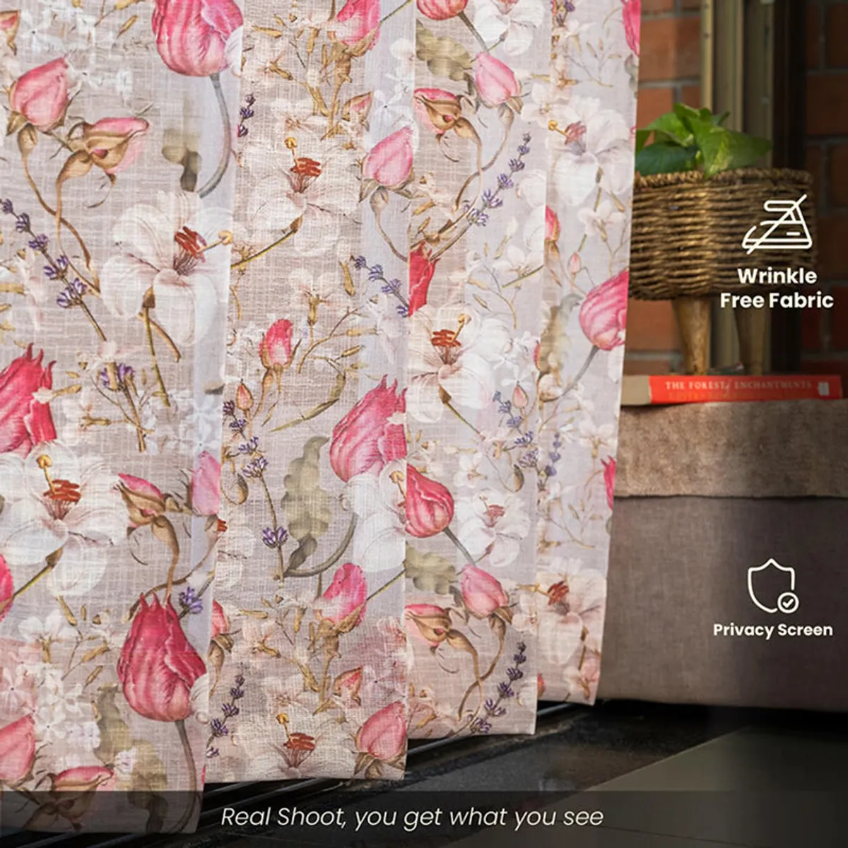 Close-up of floral curtain fabric displayed beside a sofa and plant.