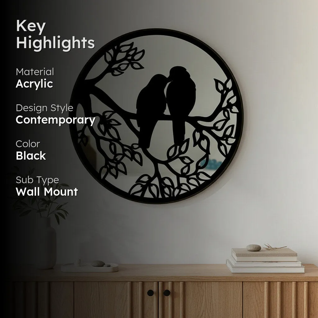 Round black wall mirror with lovebird design styled above a console
