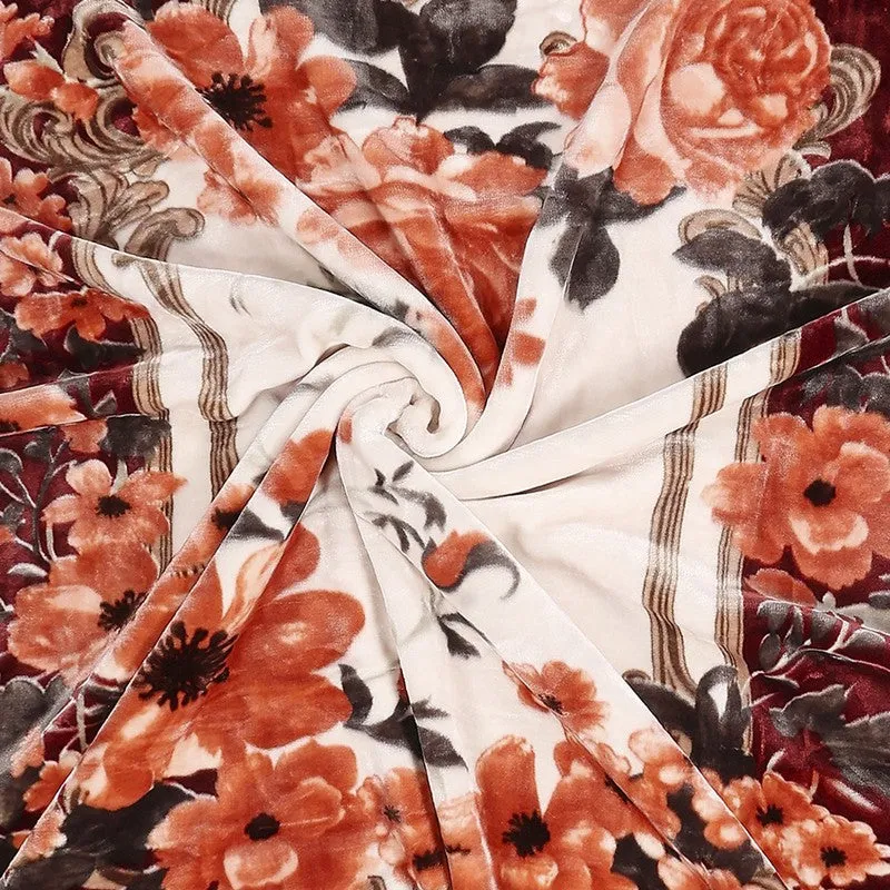 Close-up of orange floral print on the blanket's light centre