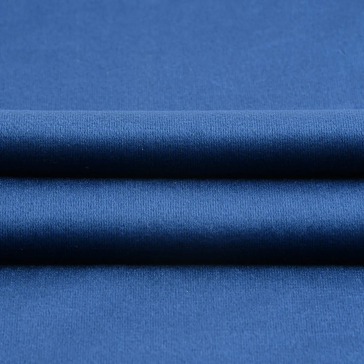 Close-up view of the blue velvet cushion cover fabric