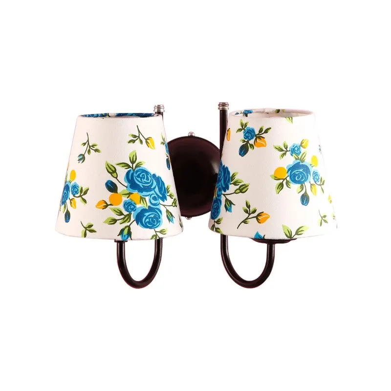 Blue and white twin wall lamp with floral printed shades on white background