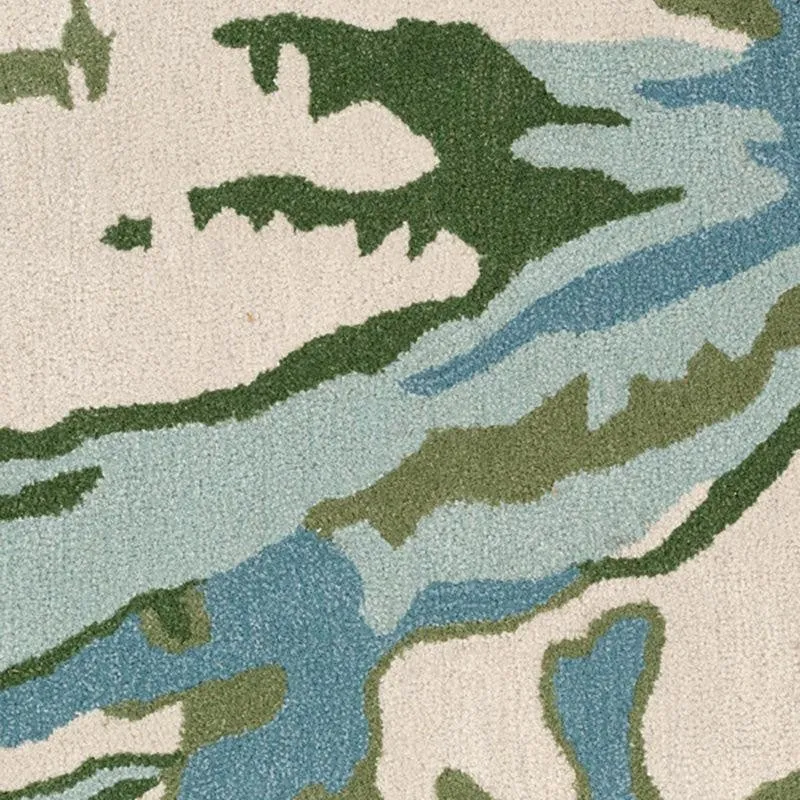 Close-up of carpet surface with blue and green abstract floral design