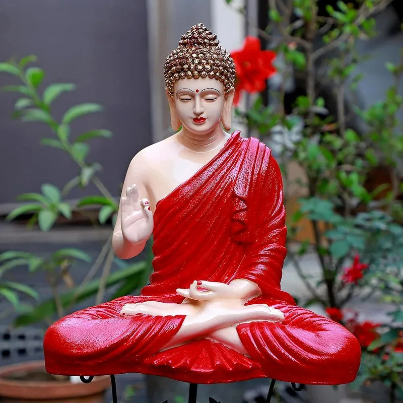 Seated Buddha showpiece in red robe with raised hand, shown outdoors