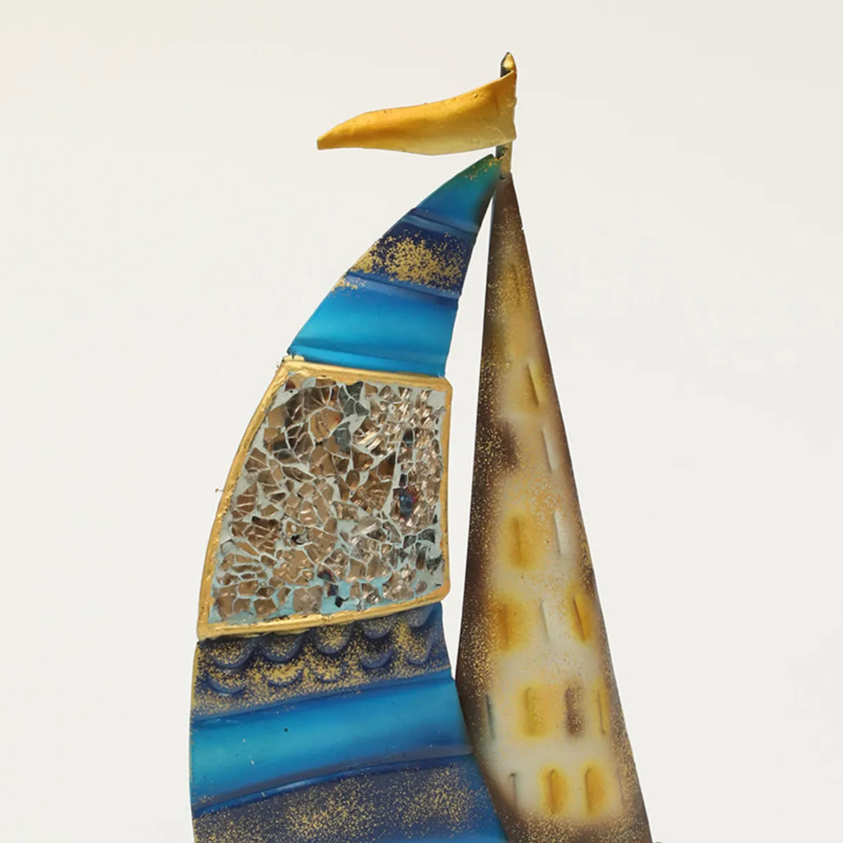 Front view of a multicolour sailboat showpiece with mosaic-style sail detail