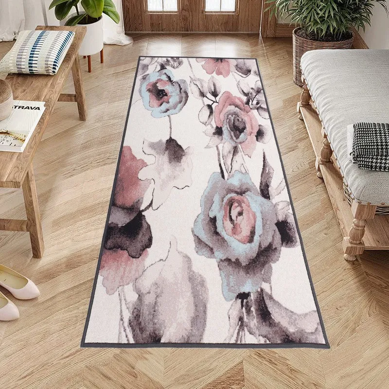 Long floral runner rug placed in an entryway with peach and grey blooms