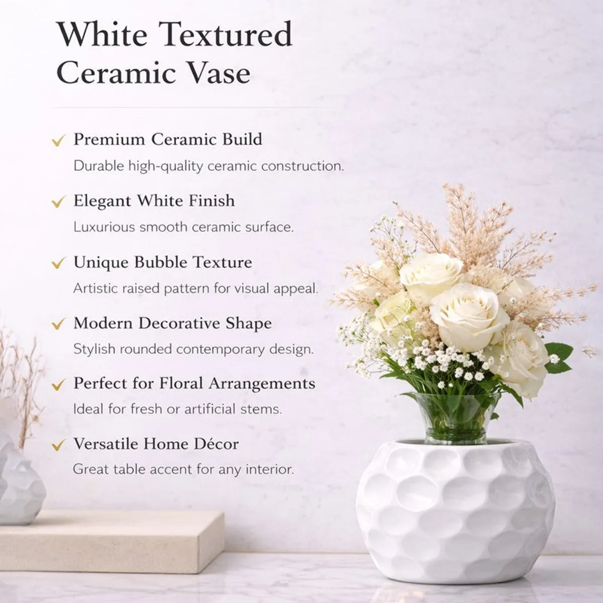 White textured vase with a cream floral arrangement on a light tabletop.