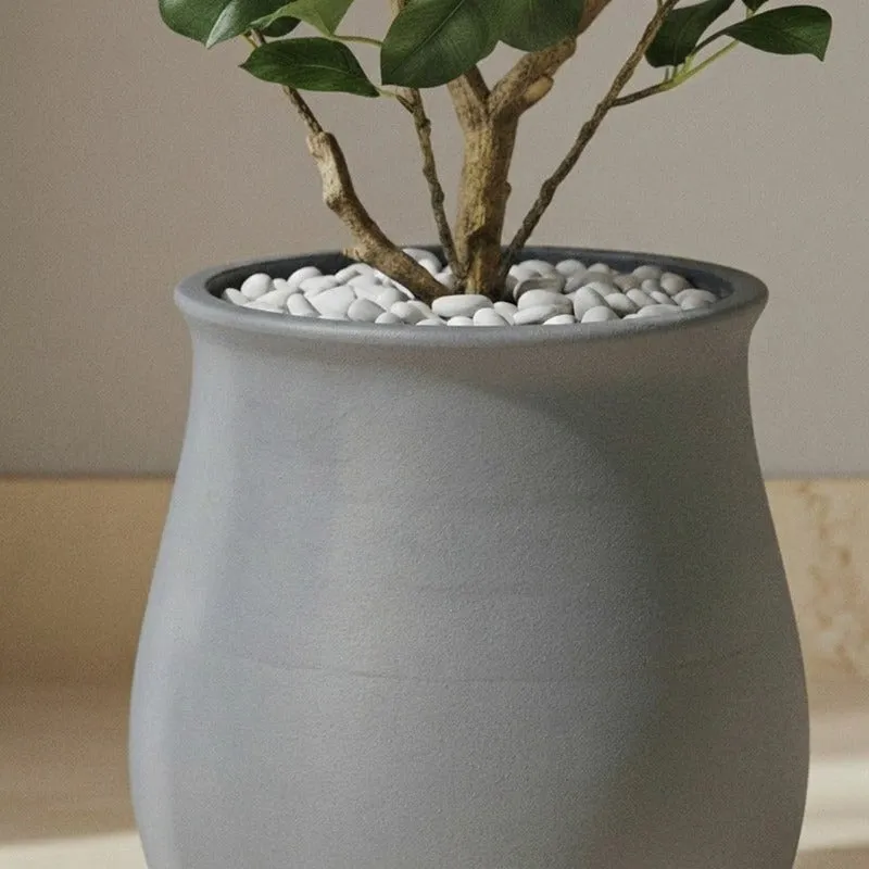 Close-up showing a leafy plant arranged inside the grey planter