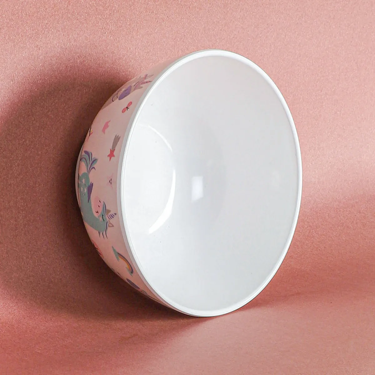 White snack bowl shown on its side, displaying pastel decorative artwork