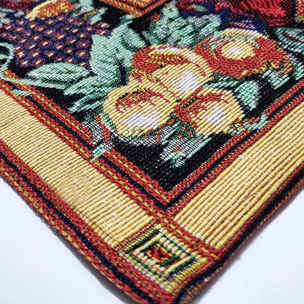 Detailed view of jacquard woven placemat with floral border and beige centre