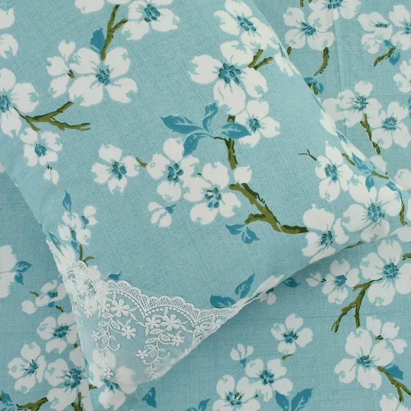 Close-up of blue floral fabric with white lace corner detail