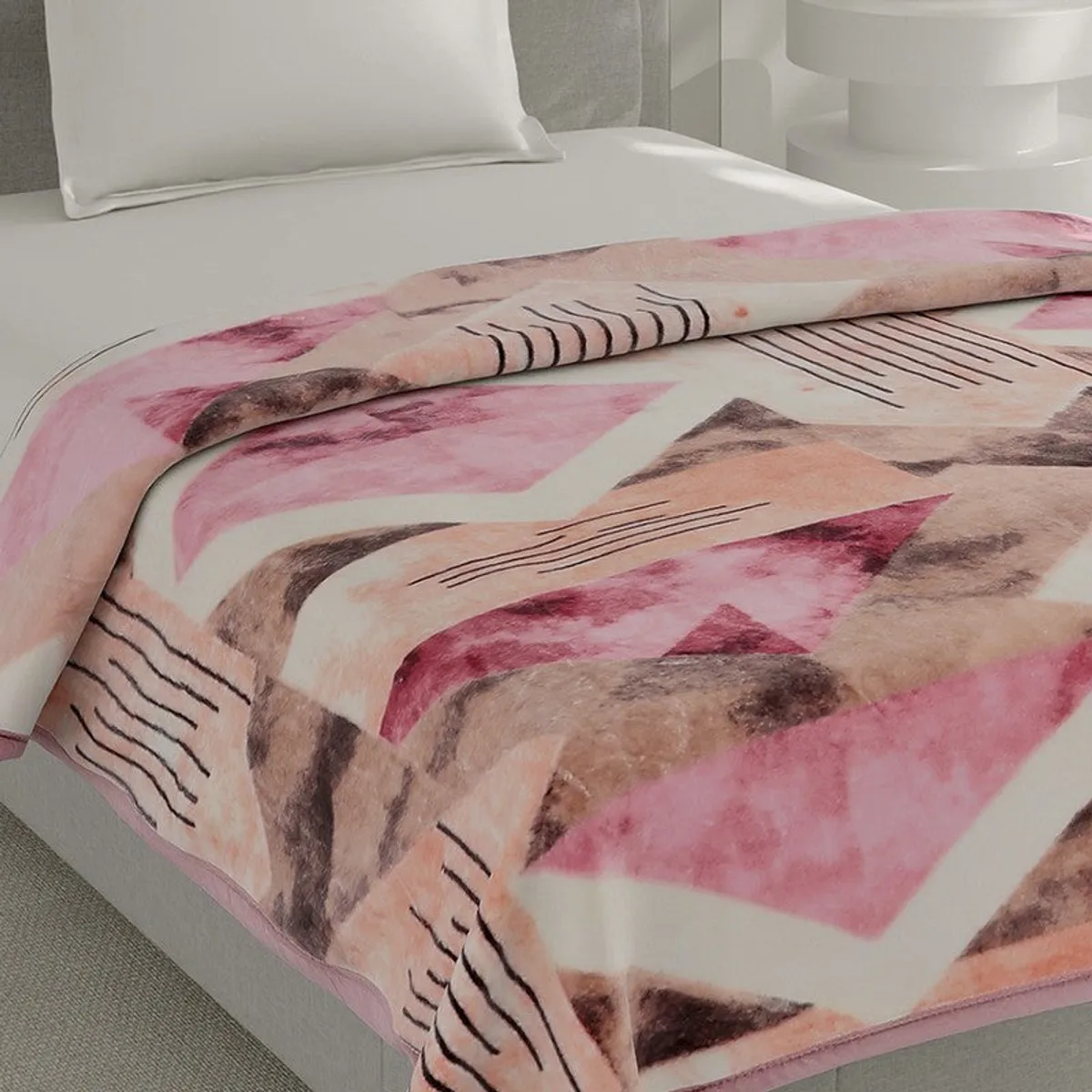 Close-up of soft pink, beige and brown patterned blanket