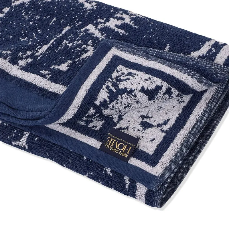 Close-up of the blue and white towel's patterned cotton texture and border