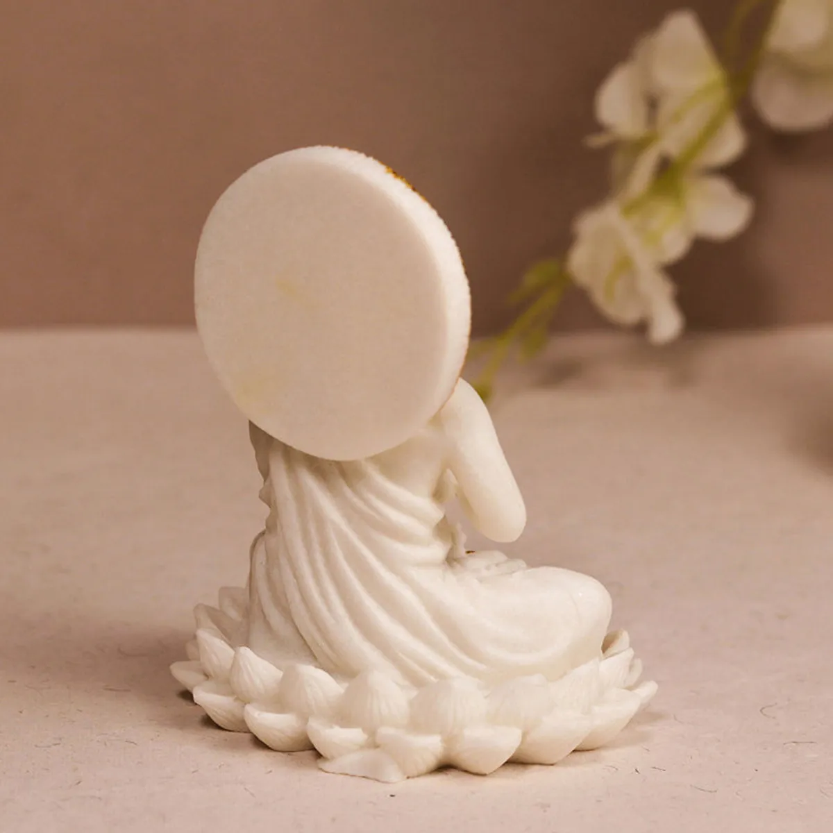 Back view of the white Buddha showpiece with circular halo and lotus base