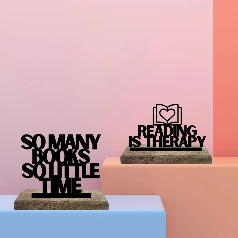 Two black typography showpieces on pastel display blocks