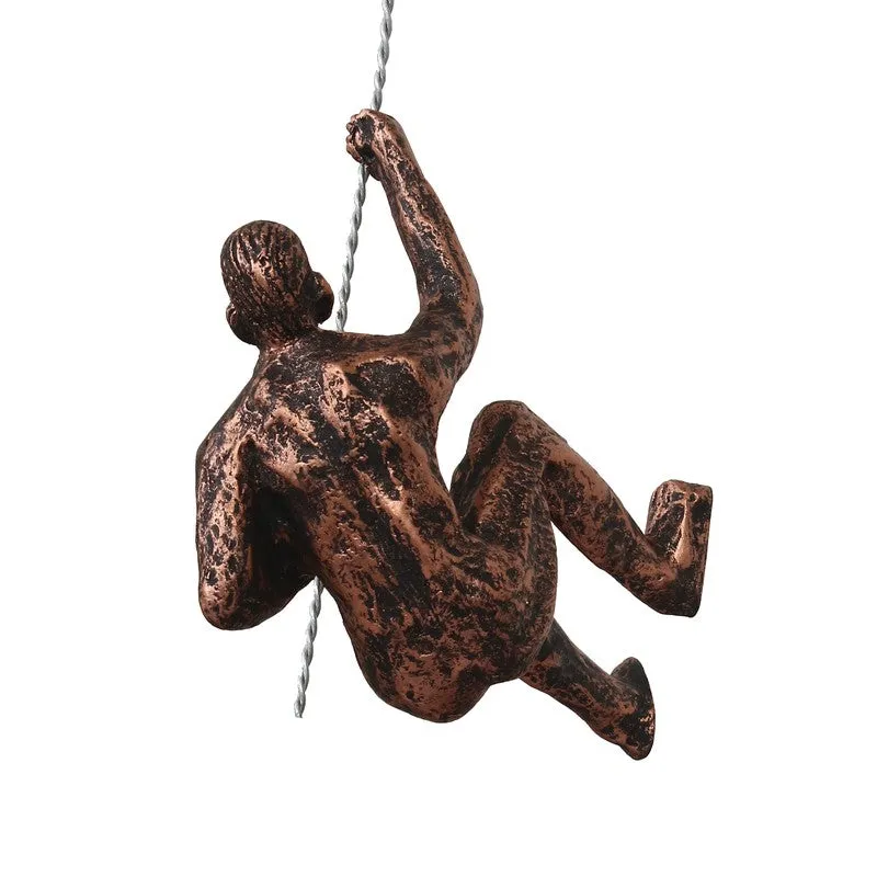 Rear view of textured bronze climbing figure wall accent