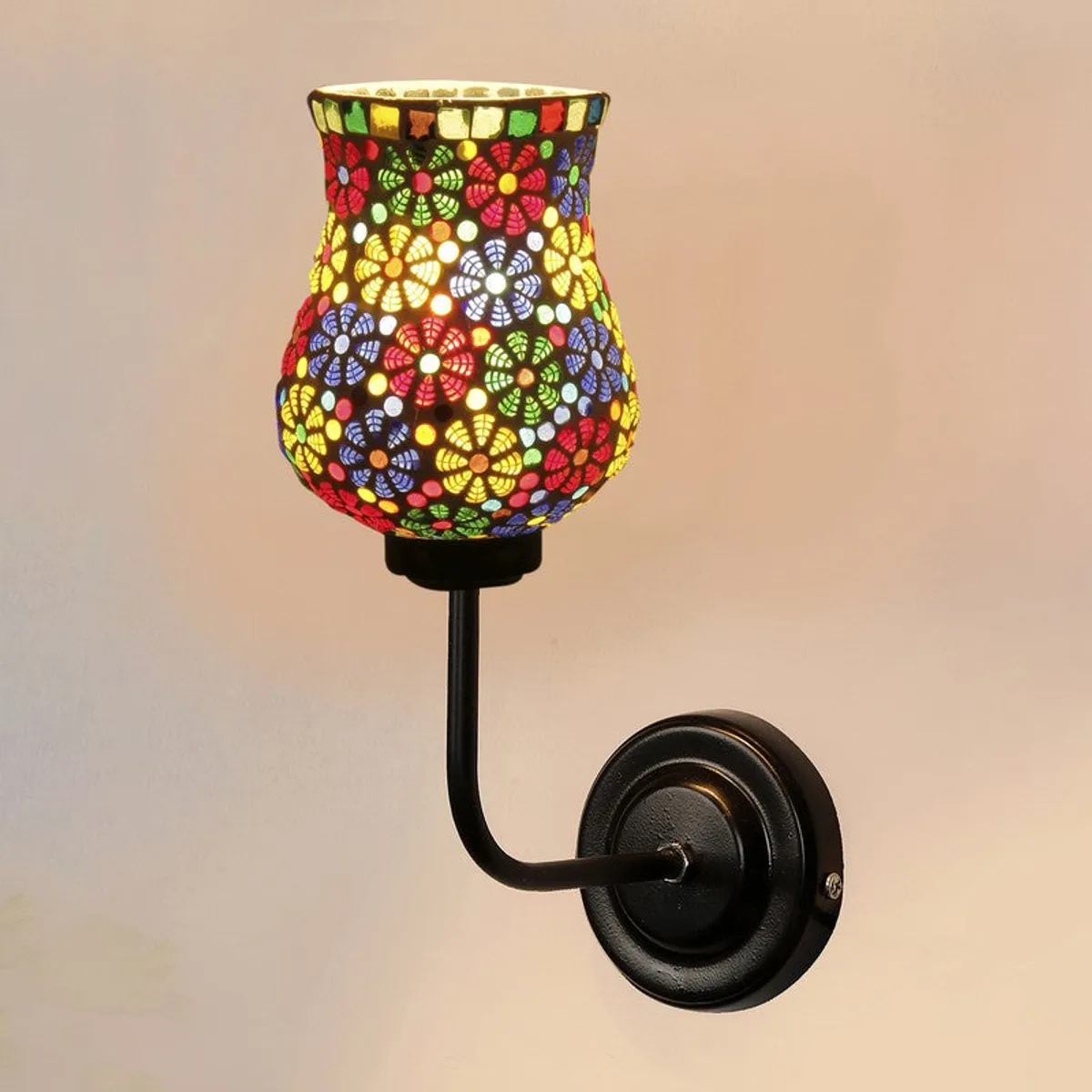 Front angled view of illuminated mosaic glass wall lamp