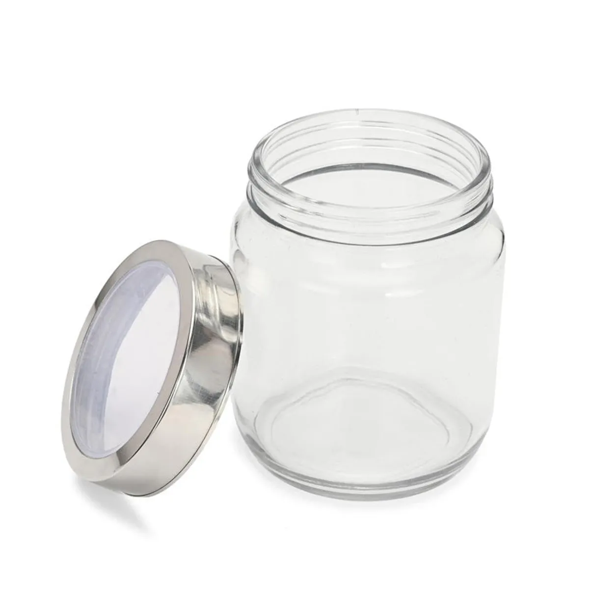 Open transparent glass jar with its metallic lid placed beside it