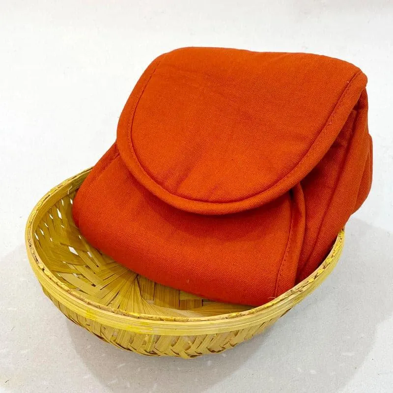 Rust cotton bread basket folded inside a woven basket