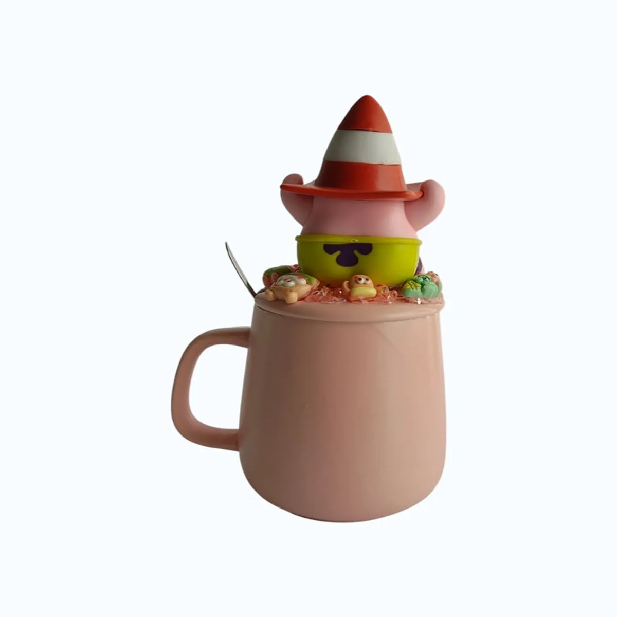 Back view of pink ceramic mug showing the figurine lid and handle