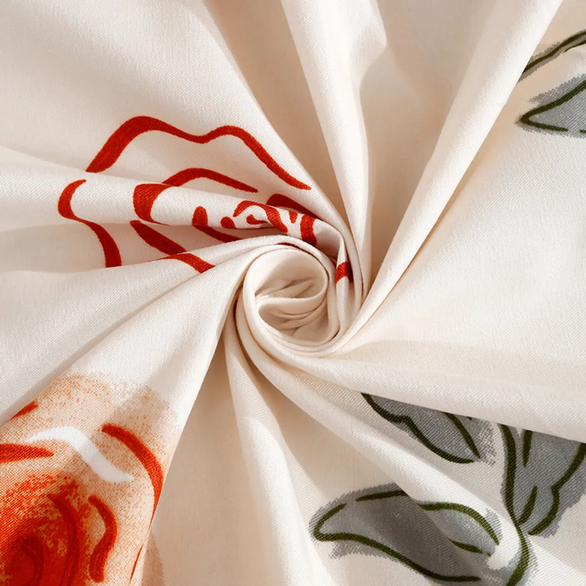 Close-up of soft ivory bedsheet fabric with a red floral print