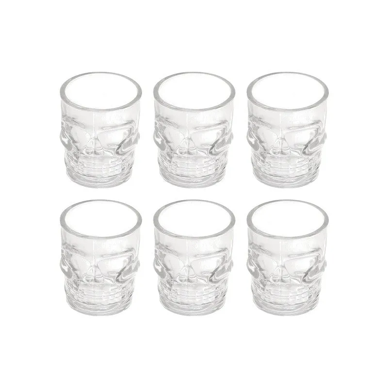Set of six clear skull-shaped shot glasses on a white background